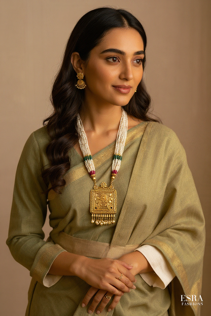 Woman wearing traditional attire with a gold necklace on a beige background